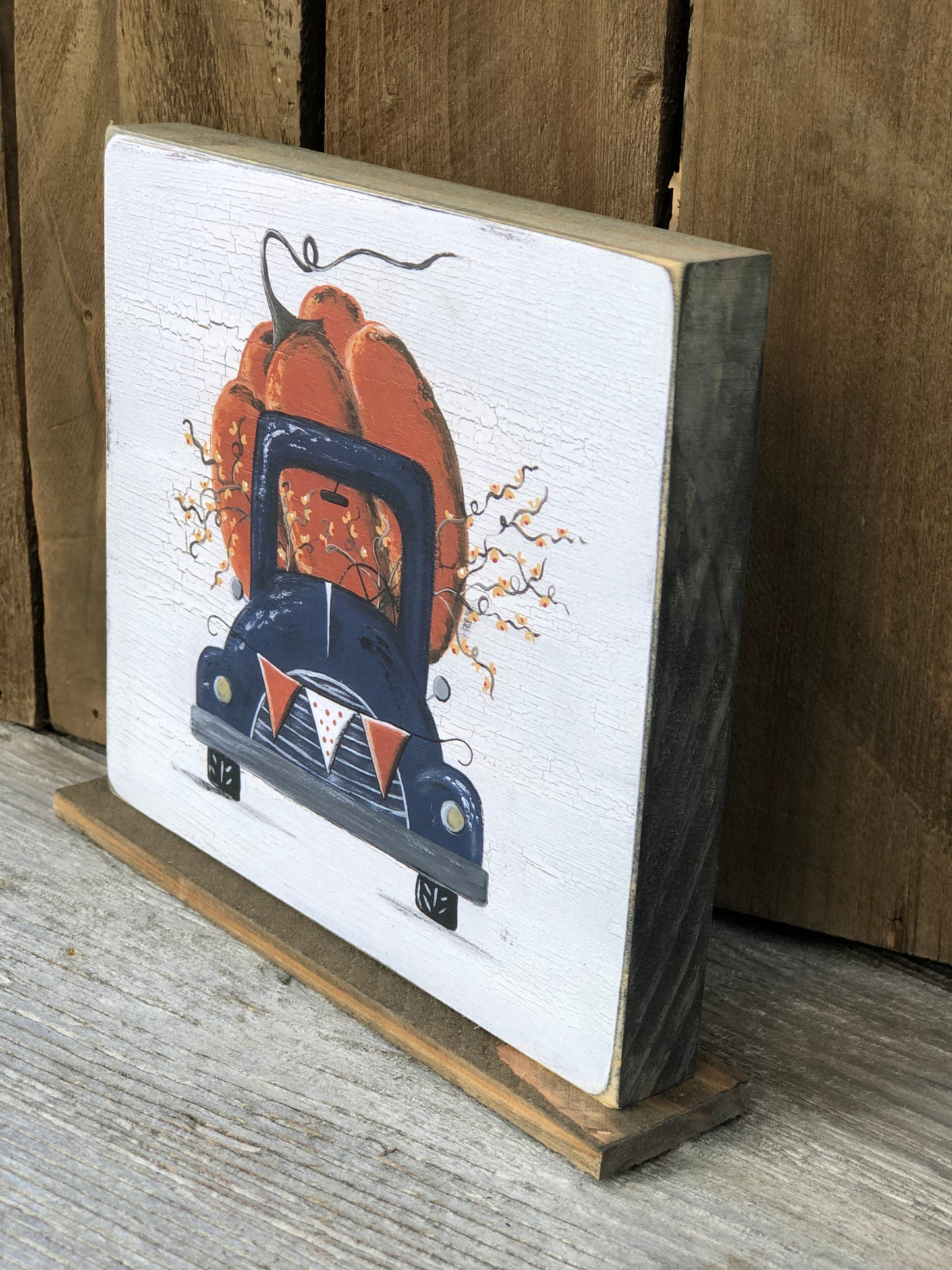 TRUCK -5.5 IN NAVY TRUCK WITH PUMPKIN PRINT ON STAND - WOOD SIGN